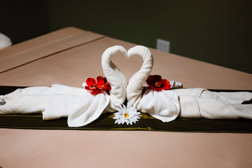 Swan towel art with flowers in the couples room at Magnolia Wellness Massage